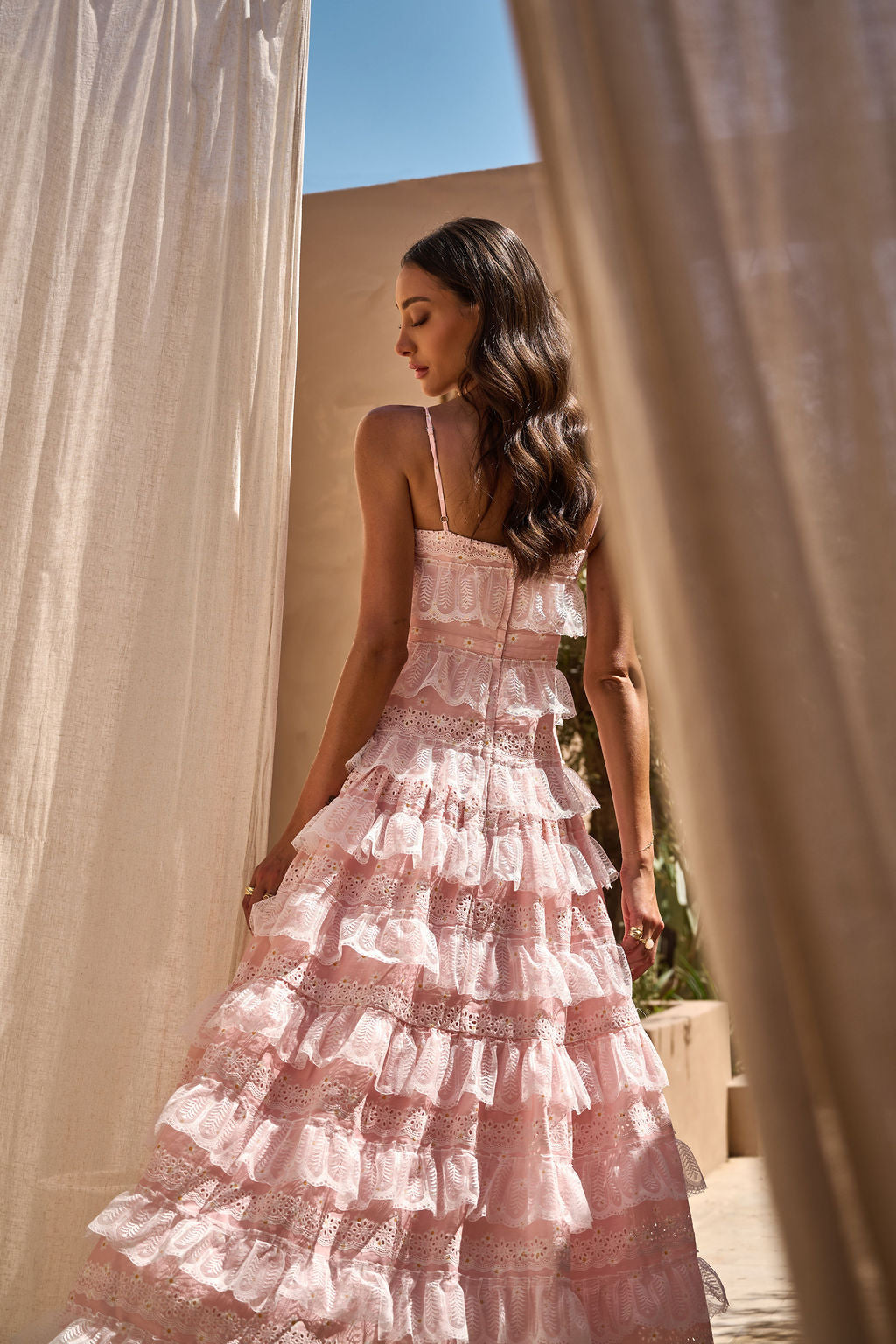 Pink ALB LOVETTE dress displayed on a hanger, showcasing its stylish design and vibrant color.
