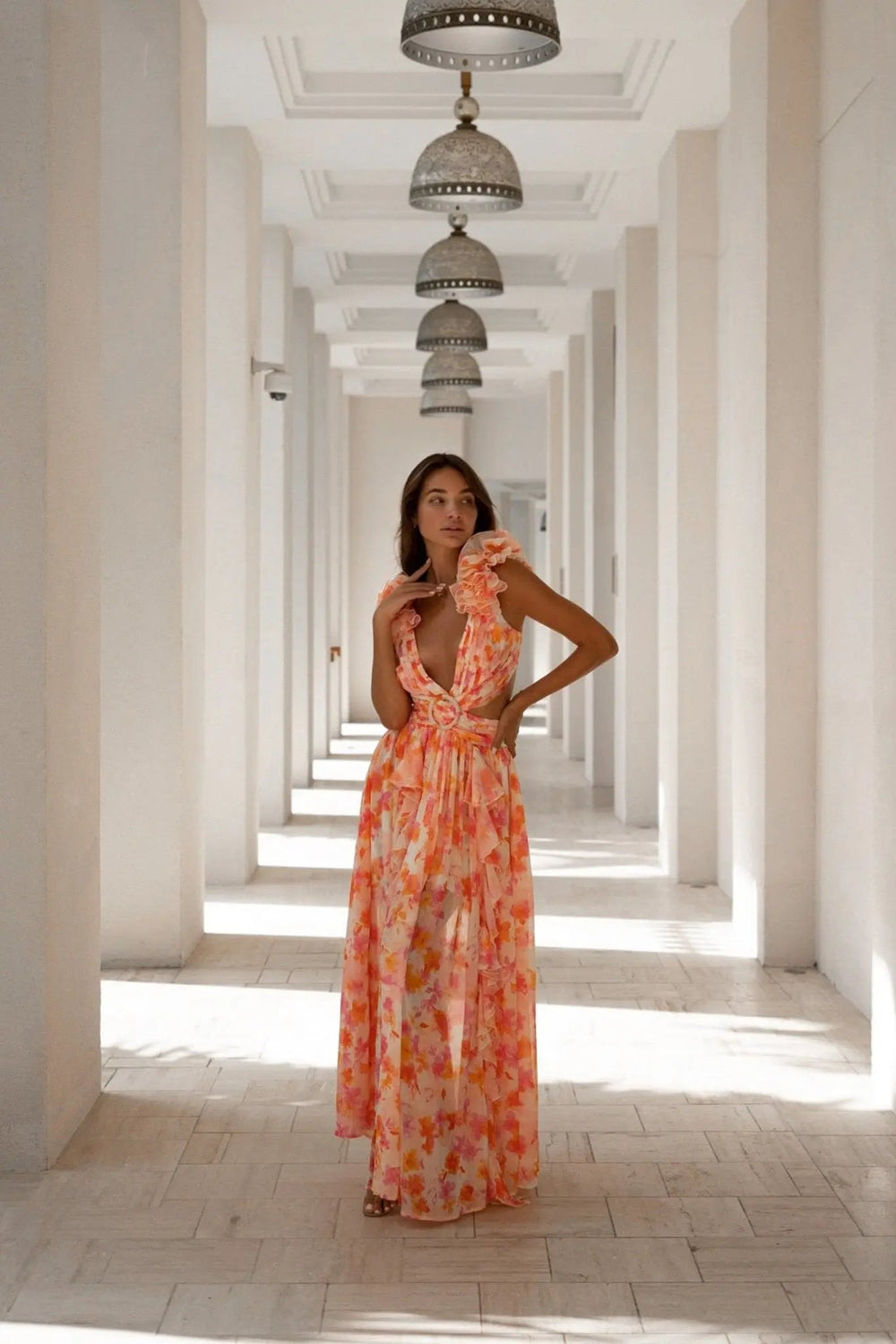 Orange and fuchsia floral Cassini maxi dress by Anne Louise Boutique, flowing fabric with a vibrant pattern.