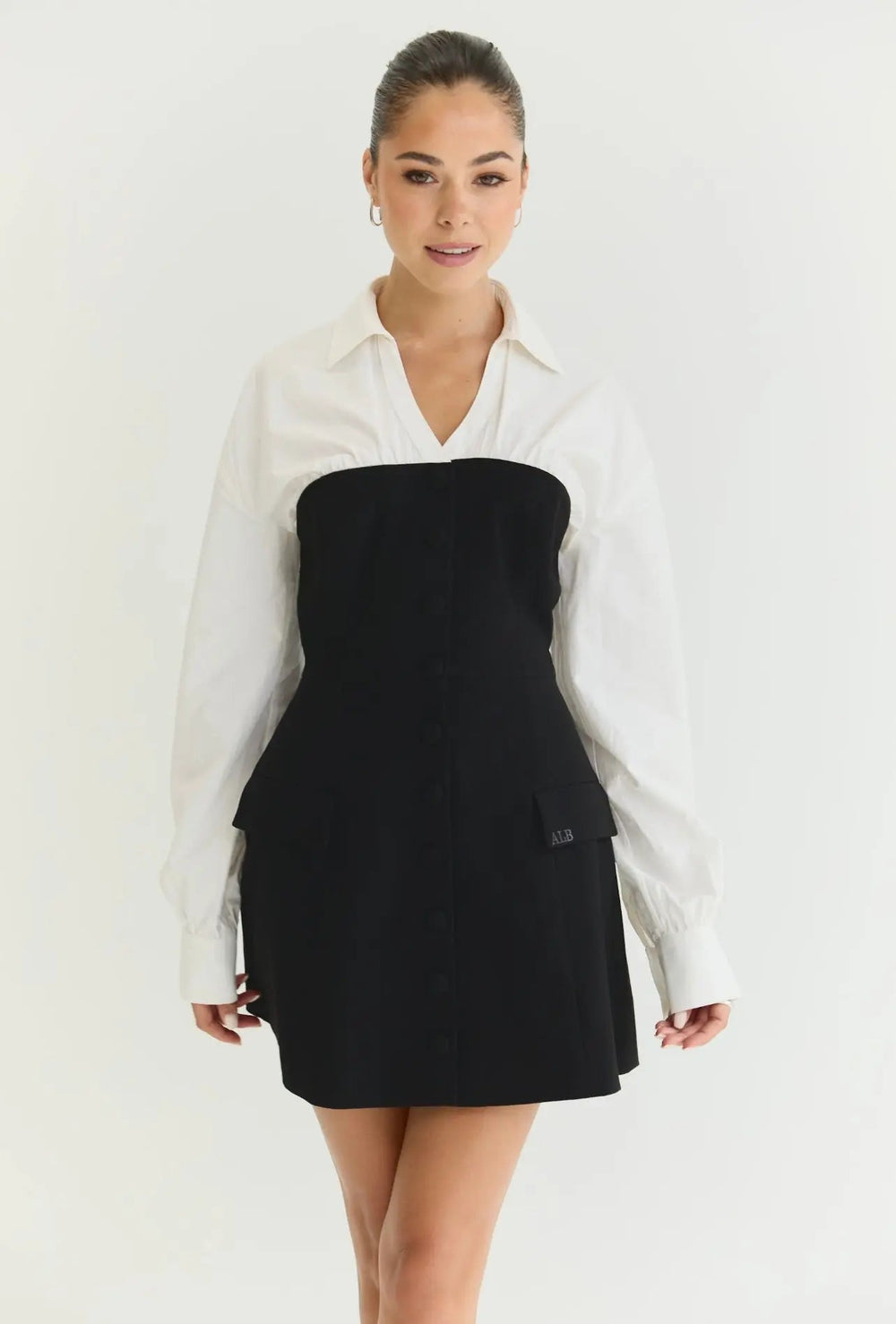 Anne Louise Boutique Cameron Dress, elegant sleeveless dress with floral pattern and flowy fabric, worn by a model.