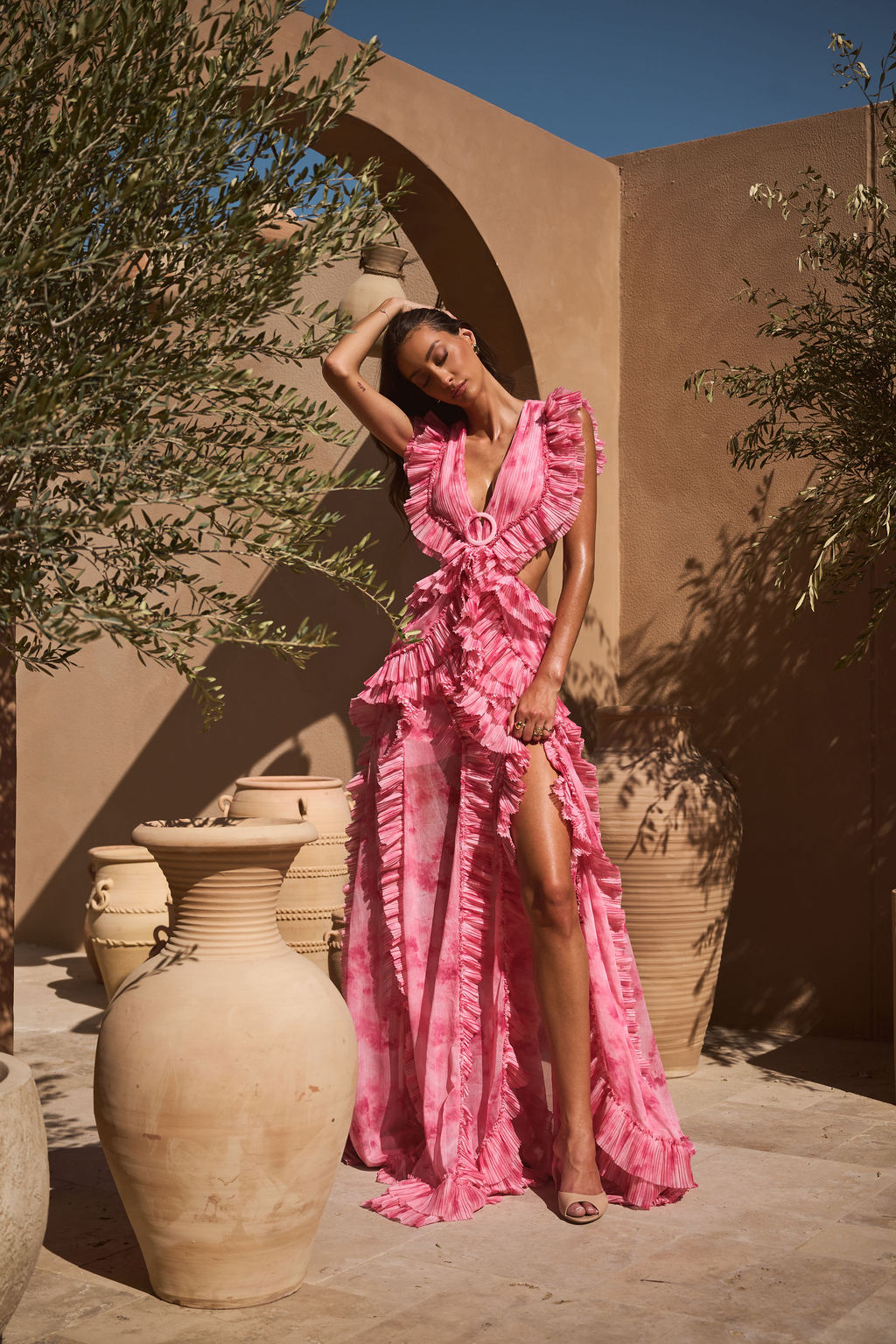 ALB London UK Rose Water Cassini Dress displayed on a hanger, showcasing the elegant floral design and soft fabric.