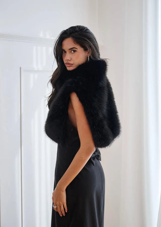Black Aspen cape by Anne Louise Boutique, flowing over a neutral outfit, showcasing elegant, lightweight outerwear with a stylish drape.