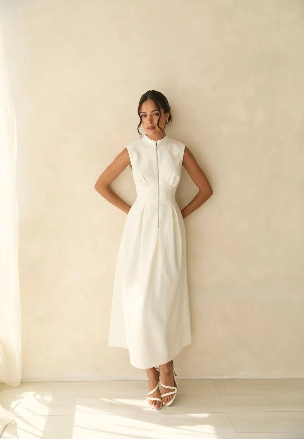 White Knightsbridge zip dress by Anne Louise Boutique, featuring a fitted silhouette and stylish front zipper detail.