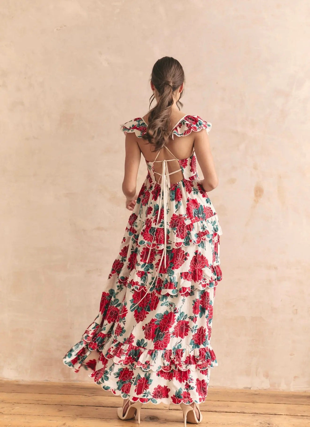 Anne Louise Boutique Monaco Rose Maxi Dress displayed on a hanger, featuring a flowing fabric and floral rose pattern.