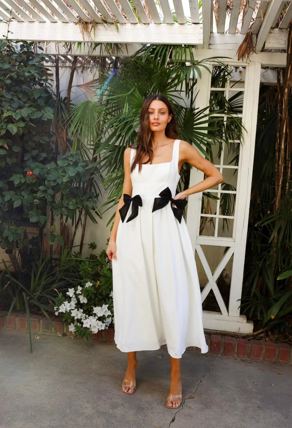 White Bow Midi Dress by Anne Louise Boutique, featuring a full-length view of the elegant dress with a bow detail and midi length.
