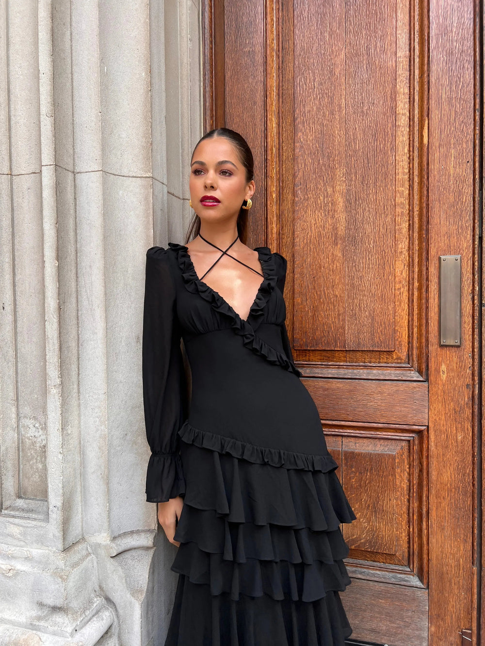 Black ruffle dress by Anne Louise Boutique featuring a stylish, feminine design with ruffled details.